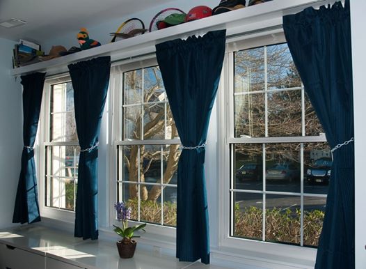 White windows with grids; Navy curtains
