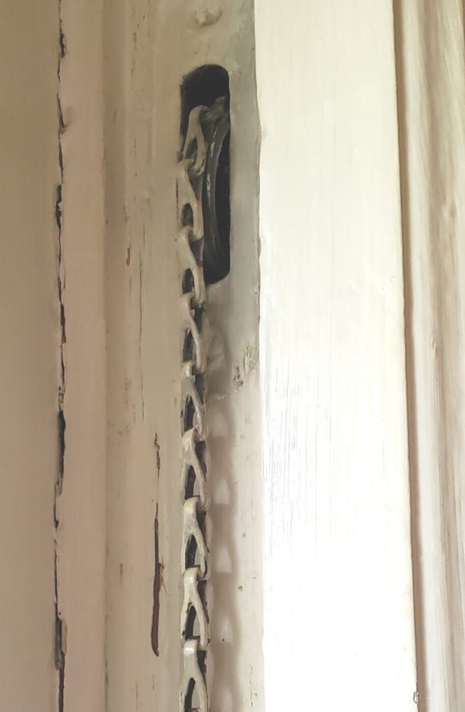 Old, window chain and pulley system used to keep windows open.