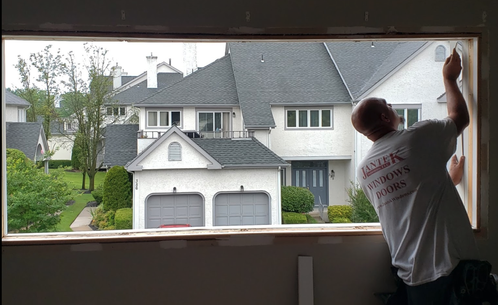 Interior view of contractor installing windows.