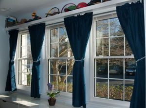 White Double Hung windows with grids with dark blue curtains