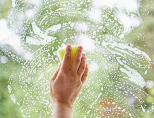 Close up of hand washing a window
