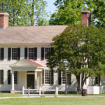 Colonial home with green shutters and hung windows