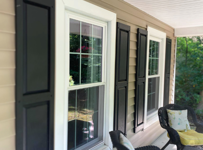 Porch view of home with double hung windows in white, with window grids.