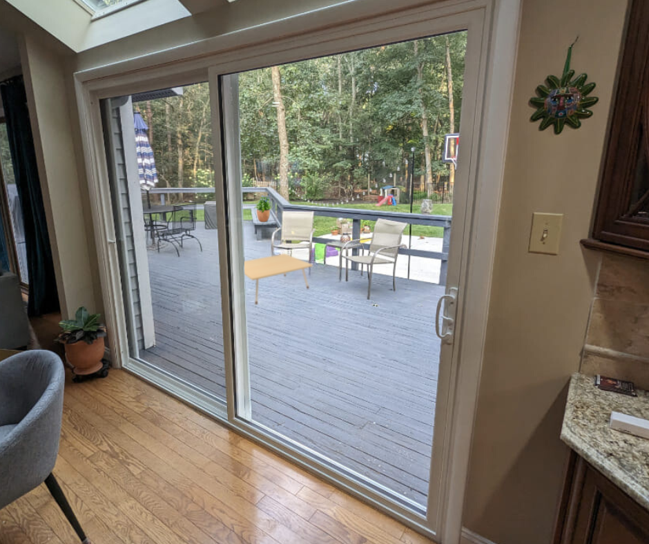 Interior view of sliding glass patio door, wooden deck