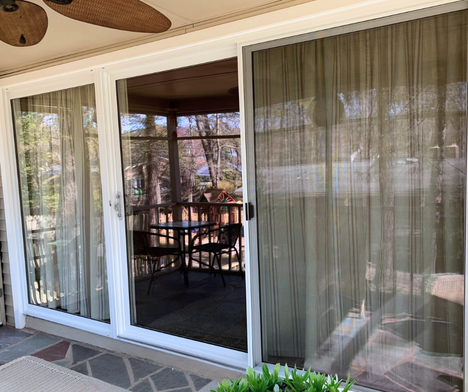 Large, three panel sliding glass door on patio.