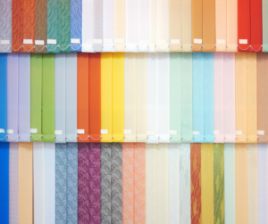 Vertical blind fabric swatches in a variety of colors and textures.