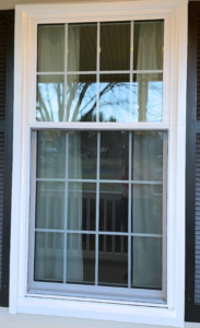 Exterior view of an Oriel Style Window with Colonial Grids in White. 